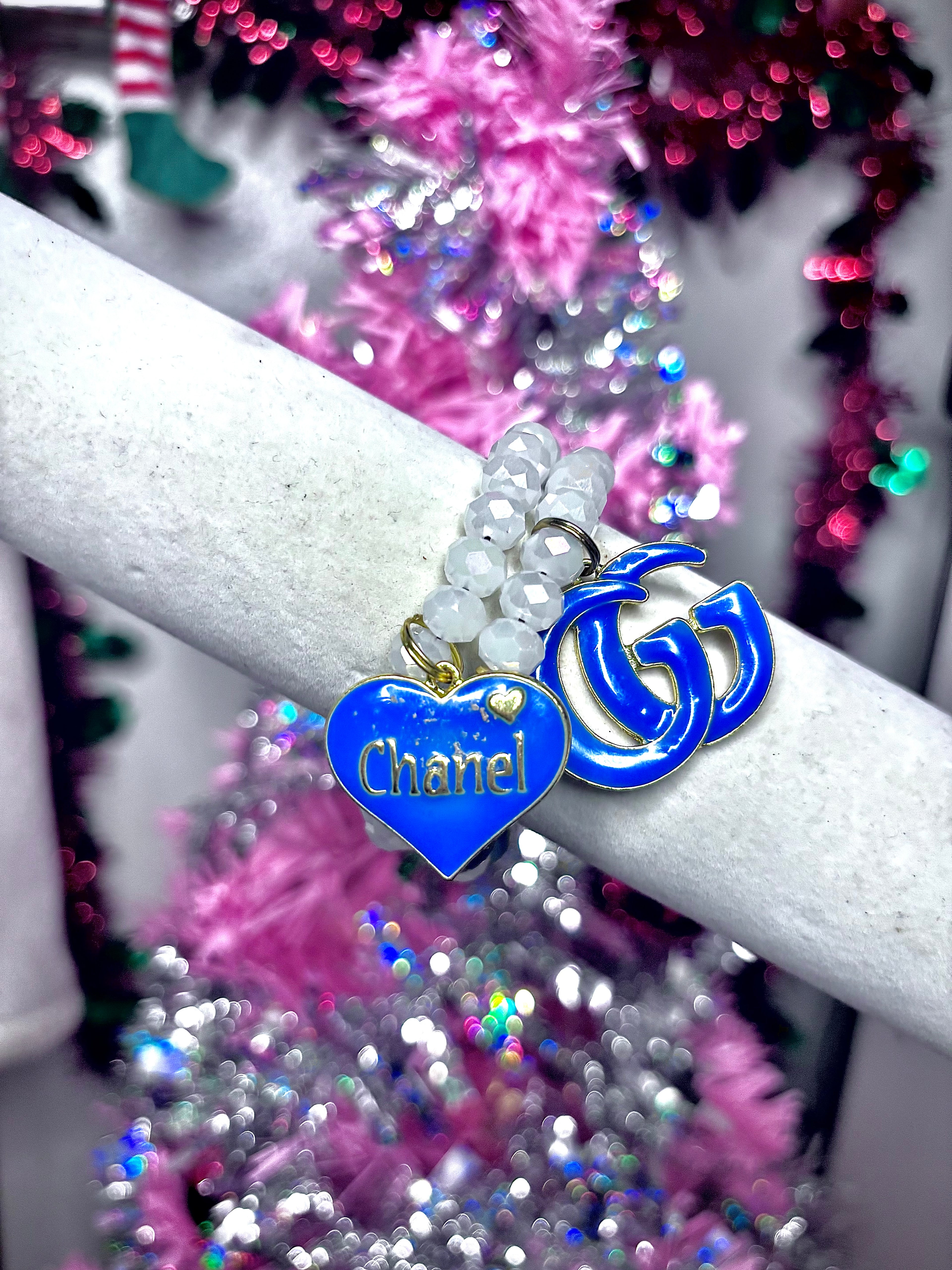 white beaded bracelet with blue designer charm